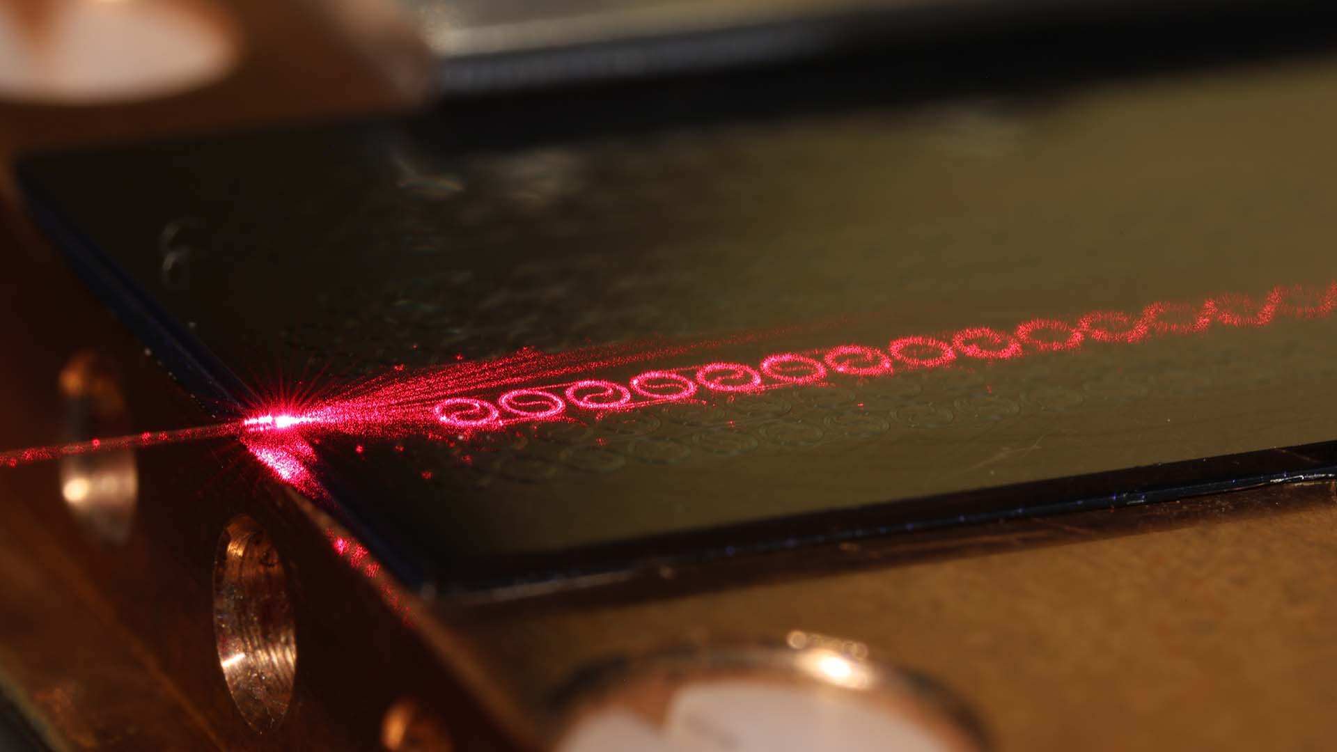 The amplifier developed by Chalmers University researchers measures just a few centimeters, yet it can process ten times larger amounts of data per second than current optical communication systems. The amplifier features a pattern of spiral-shaped, interconnected waveguides that efficiently direct the laser beam with high precision and minimal loss. Courtesy of Chalmers University of Technology/Vijay Shekhawat.