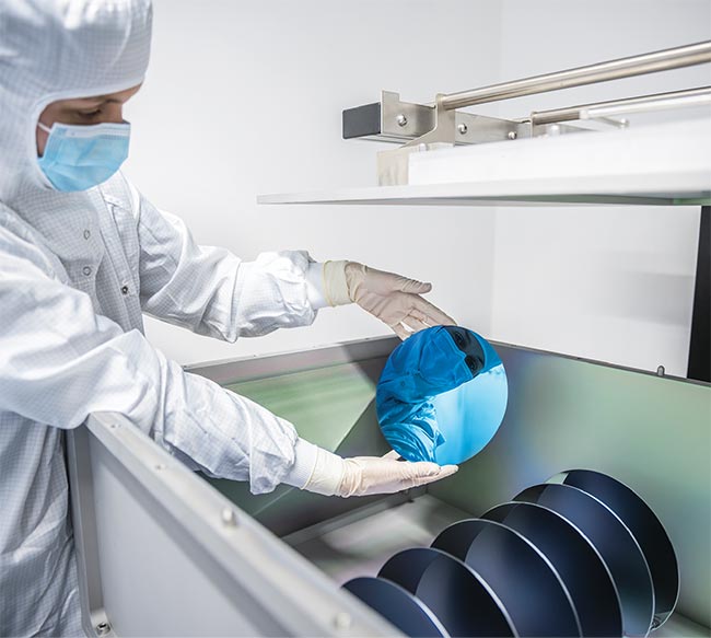 A researcher holds a highly reflective mirror for laser applications. The technology is to be optimized for laser fusion. Courtesy of Fraunhofer IOF.