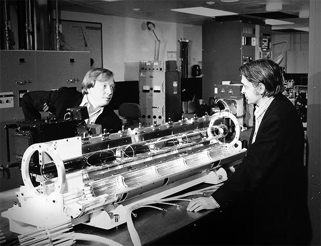 In this photo from the 1970s, celebrated physicists John Emmett (left) and John Nuckolls, visionaries in early laser fusion technology, discuss flashlamp-pumped, solid-state laser technology. Courtesy of Lawrence Livermore National Laboratory.