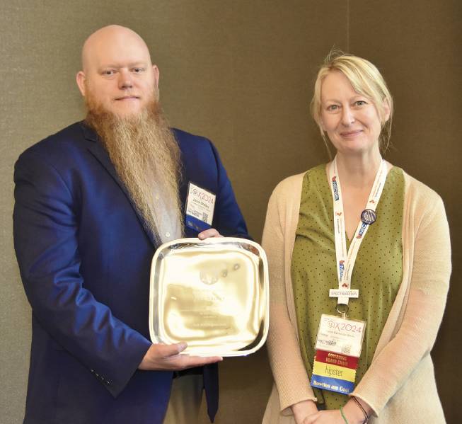 Jacob Shelley of Rensselaer Polytechnic Institute (left), the program chair for last year’s event, is presented with a service award from Karen Esmonde-White, last year’s governing board chair at SCIX. Courtesy of Glen Jackson/FACSS.
