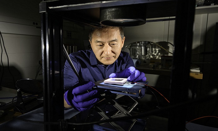 Rochester researcher Chunlei Guo tests a solar thermoelectric generator (STEG) etched with femtosecond laser pulses to boost solar energy absorption and efficiency. His lab’s innovative black metal technology design helps create a STEG device 15 times more efficient than previous devices, paving the way for new renewable energy technologies. Courtesy of the University of Rochester/J. Adam Fenster.