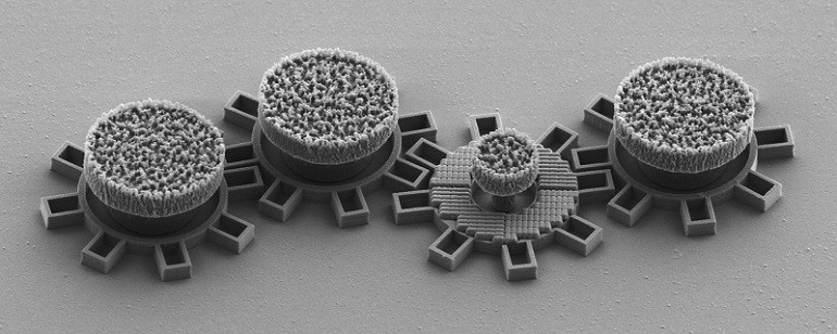 The second gear from the right has an optical metamaterial that reacts to laser light and causes the gear to move. All gears are made in silica directly on a chip. Each gear is about 0.016 millimeters (mm) in diameter. Courtesy of Gan Wang.