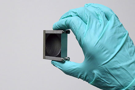 Artificial Dielectric-Based Lens Enables Efficient Terahertz-Wave Control